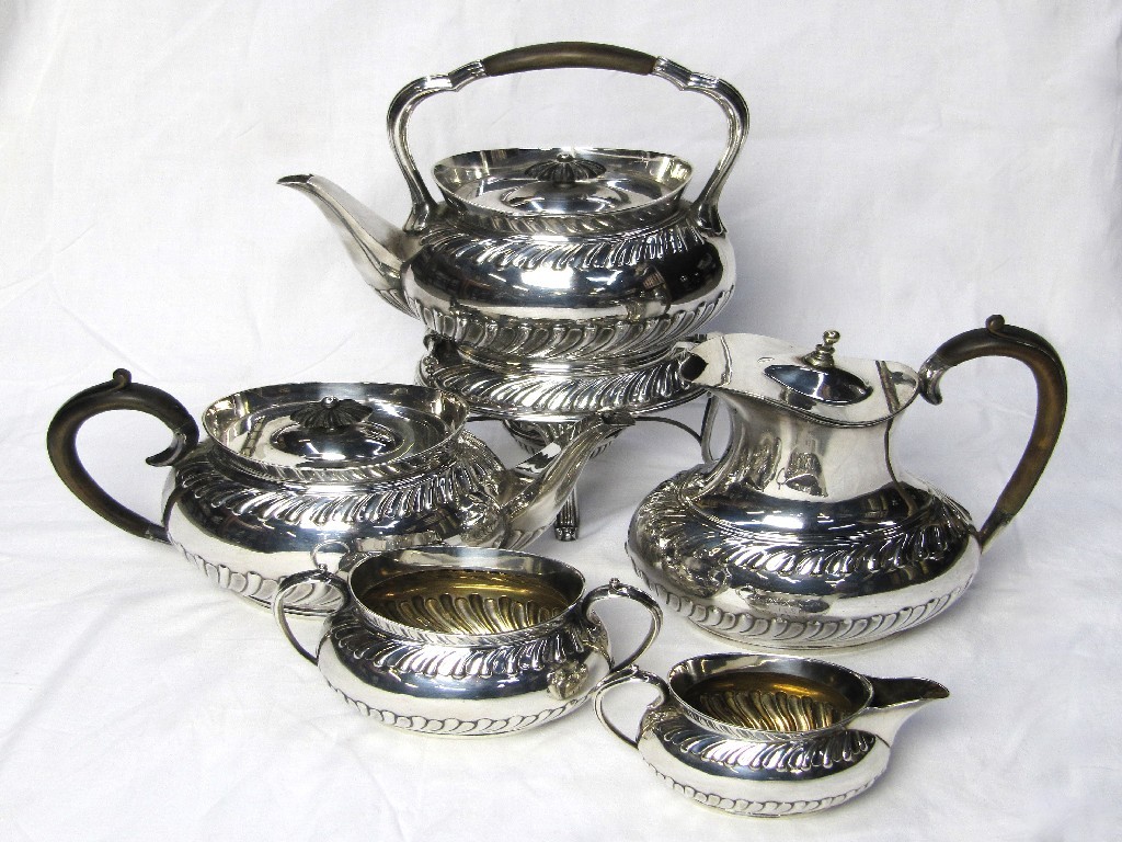 Appraisal: A Victorian five piece electroplated teaservice cast with wrythen flutes