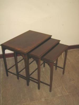 Appraisal: A NEST OF THREE MAHOGANY TABLES of oblong form with