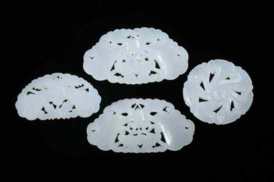 Appraisal: FOUR CHINESE RETICULATED WHITE JADE PENDANTS Three pieces carved to