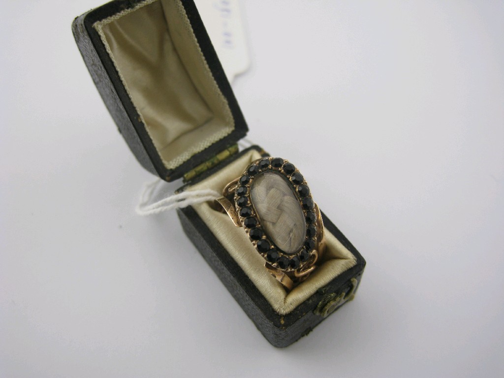 Appraisal: A Georgian Mourning Ring the twisted oval plaque enclosing lock