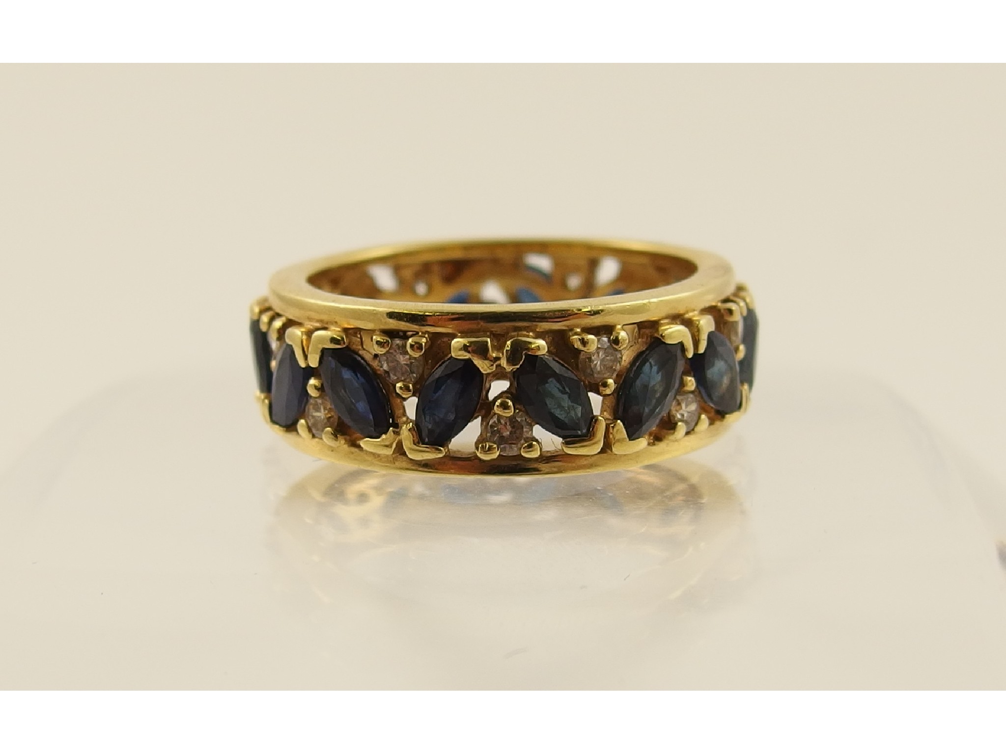 Appraisal: An abstract designed full eternity ringset with marquis sapphires and