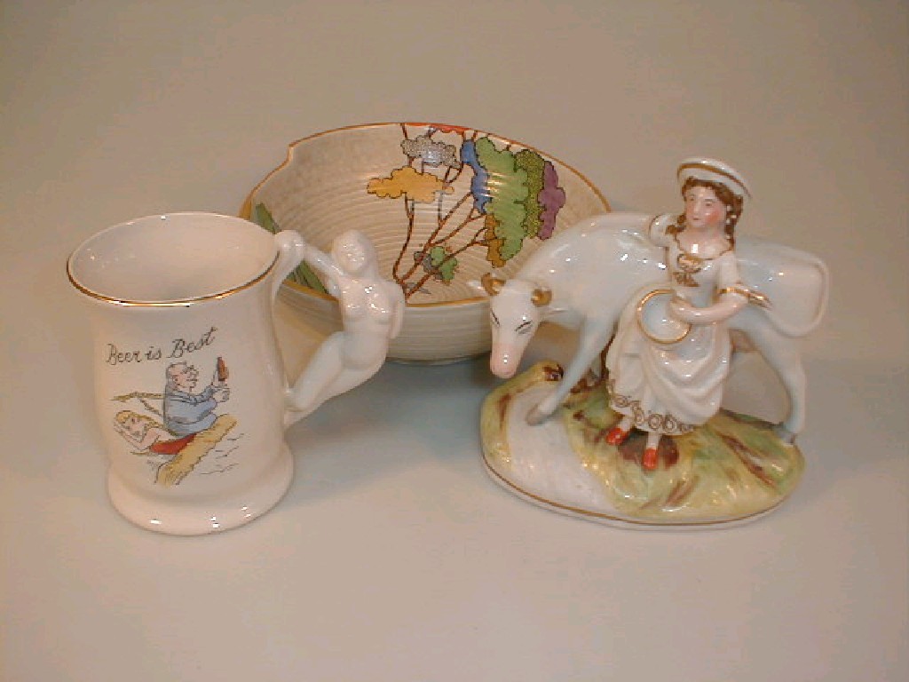 Appraisal: A Staffordshire porcelain figure of a cow and a milk