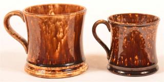 Appraisal: Two Rockingham Glazed Yellowware Mugs Concave sides and loop handles