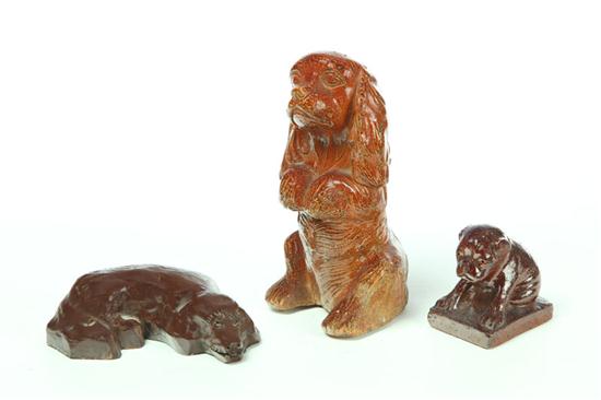 Appraisal: THREE POTTERY DOGS American early th century Two are sewertile