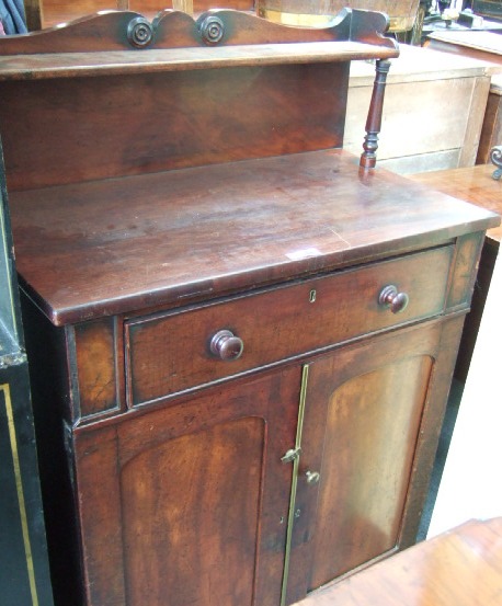 Appraisal: An early th century mahogany chiffonier the ledge back with