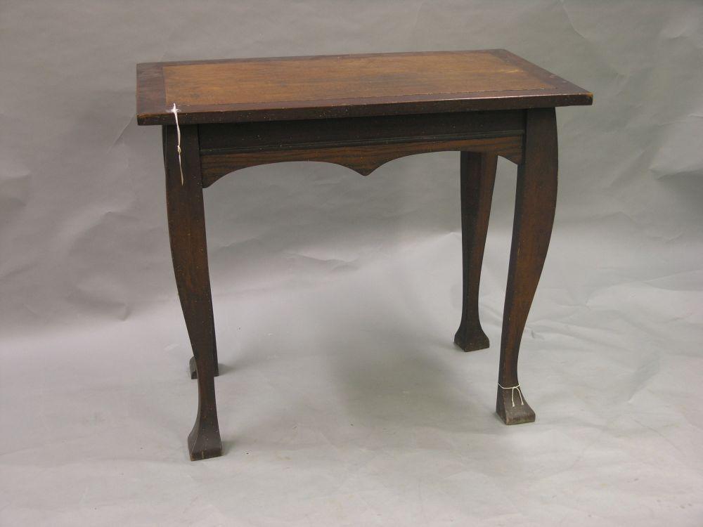 Appraisal: An oak and walnut hall table on four cabriole legs