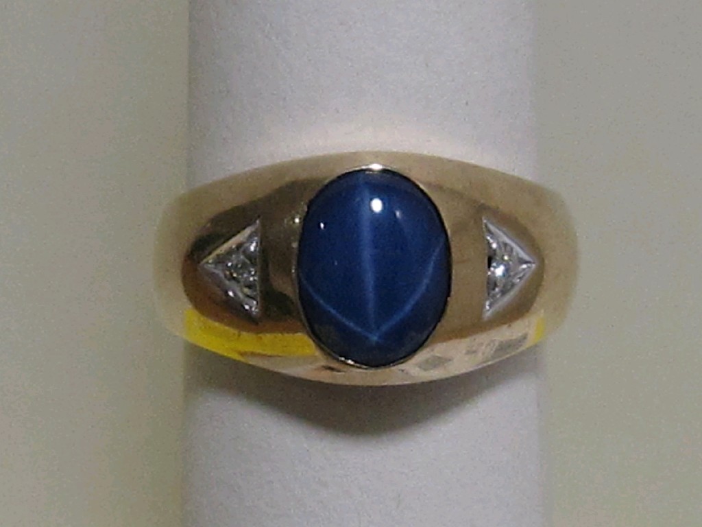 Appraisal: Nine carat gold star sapphire and diamond set dress ring