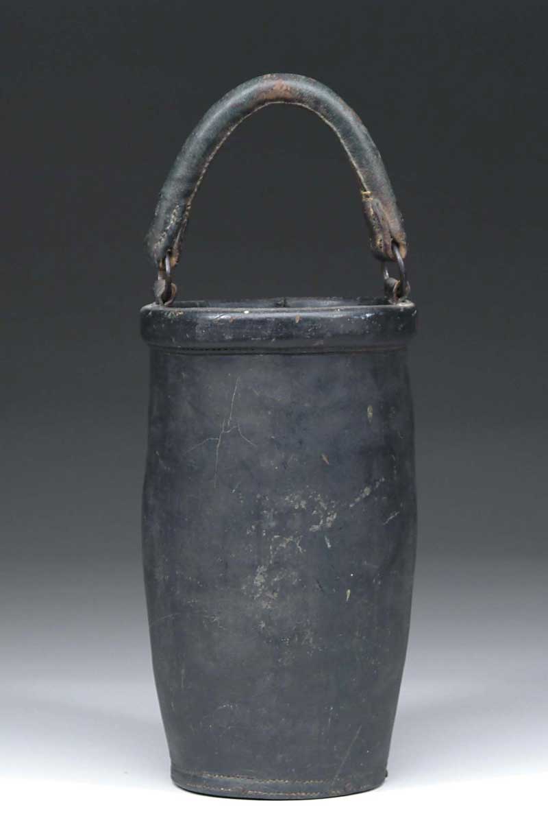 Appraisal: GREENISH BLACK PAINTED LEATHER FIRE BUCKET Unusual wood base which