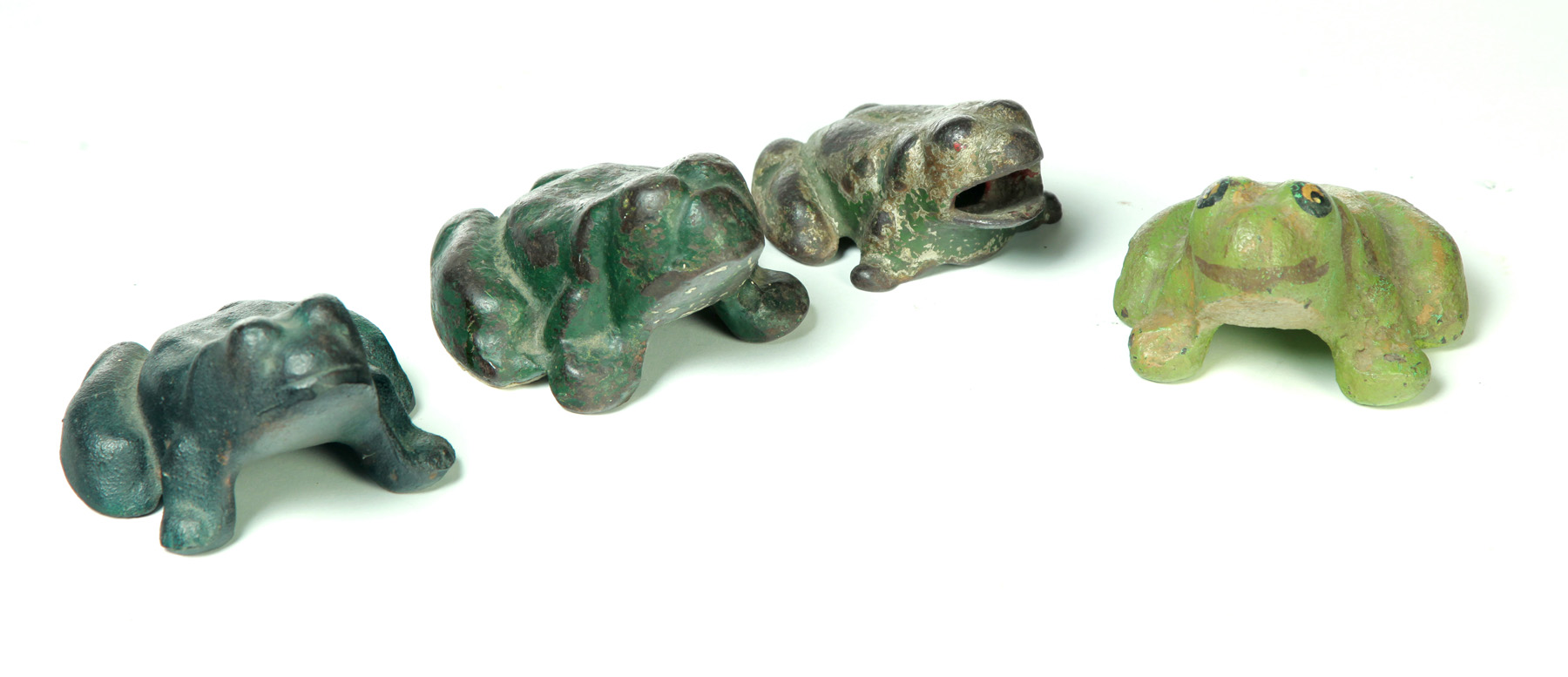 Appraisal: FOUR CAST IRON FROG DOORSTOPS American st quarter- th century