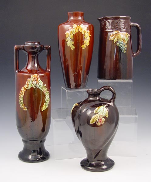 Appraisal: GROUP OF PETERS REED POTTERY VASES All brown glaze decorated