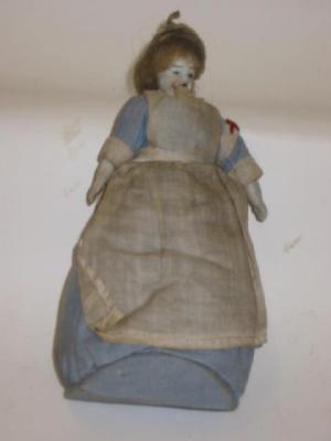 Appraisal: A bisque head pin cushion doll modelled as a Red