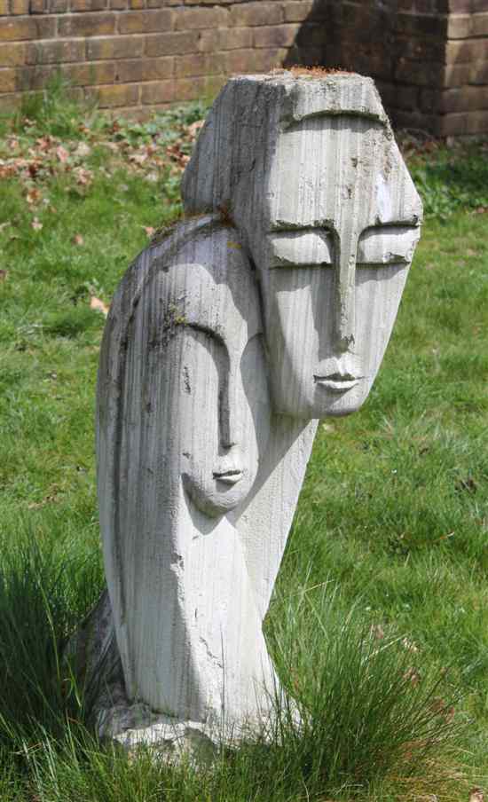 Appraisal: A composition garden ornament decorated with two heads in the