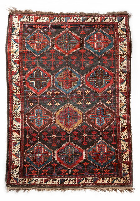 Appraisal: AN OLD KURDISH RUG with a design on polychrome interlinked