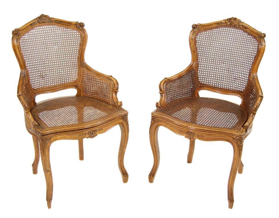 Appraisal: A pair of carved walnut fauteuil in Louis XV style