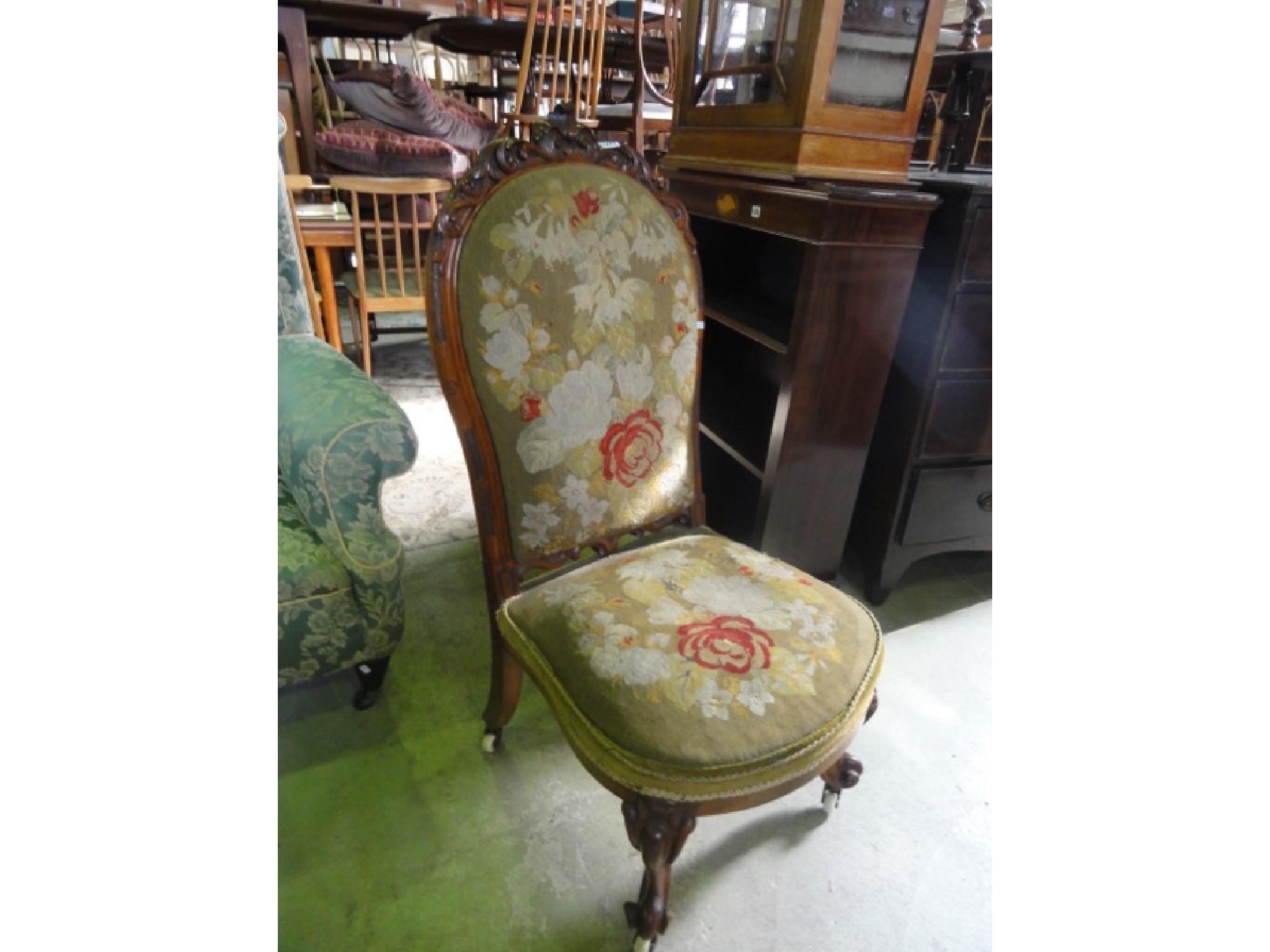 Appraisal: A Victorian nursing chair with floral tapestry upholstered seat and