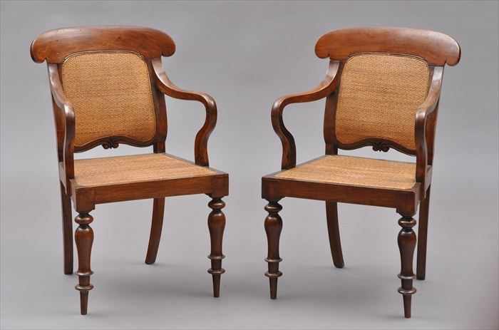 Appraisal: PAIR OF ANGLO-INDIAN CARVED HARDWOOD ARMCHAIRS Each with shaped crest