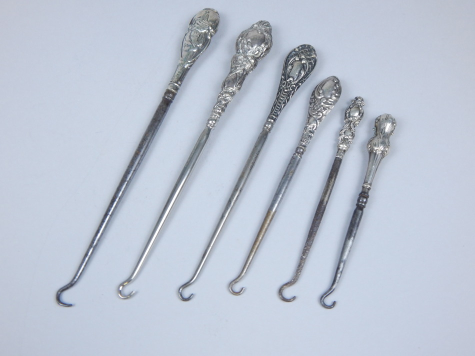 Appraisal: Five late th early thC silver mounted button hooks various