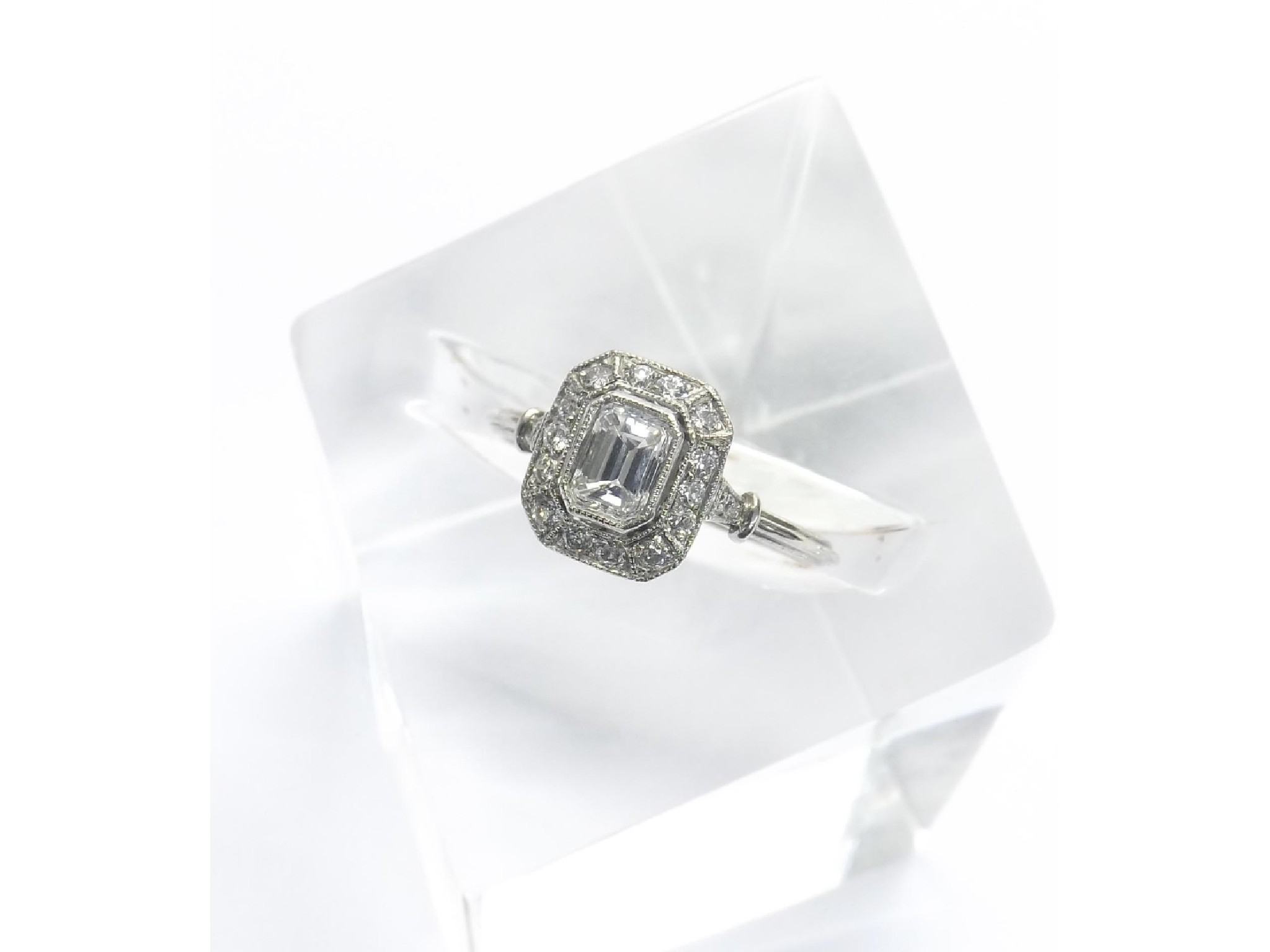 Appraisal: Good quality platinum emerald cut cluster ring the centre stone