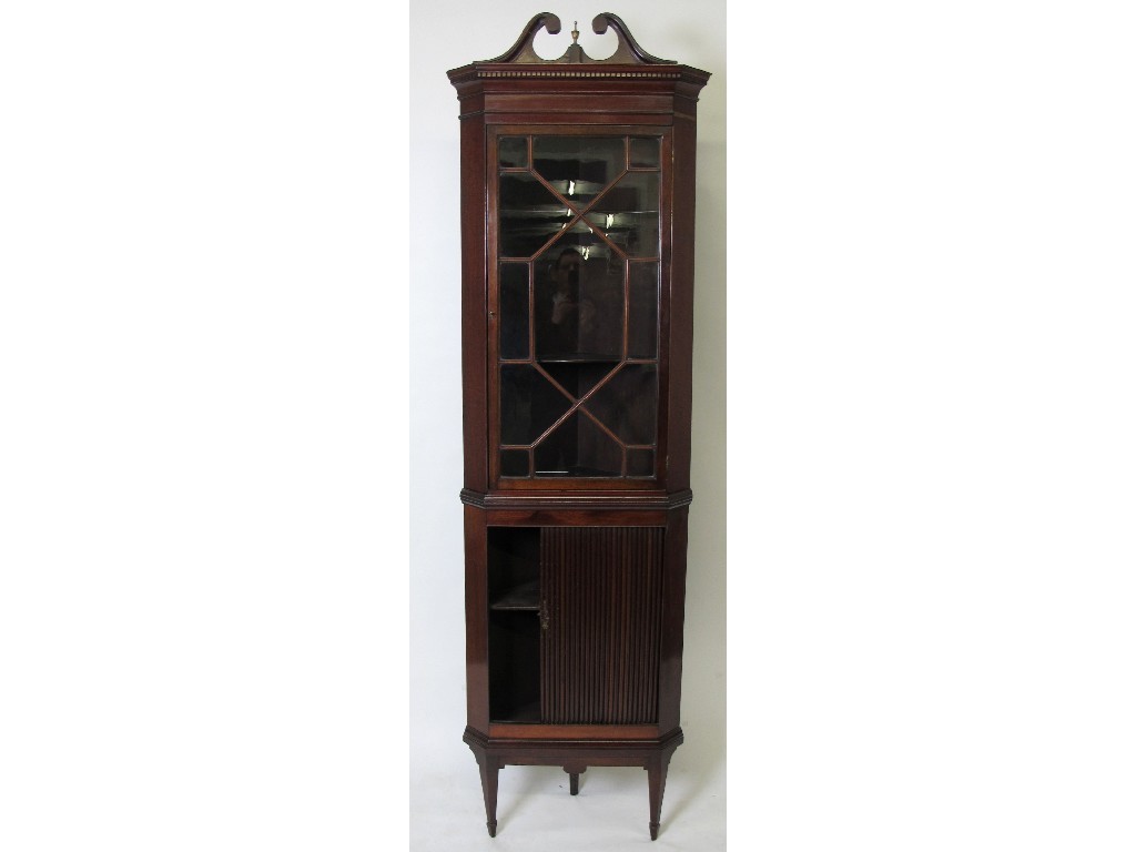 Appraisal: An Edwardian mahogany corner cabinet on stand the top with