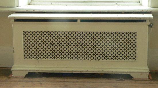 Appraisal: A single pierced cast radiator surround with pierced returns and