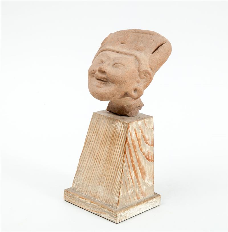 Appraisal: VERACRUZ POTTERY HEAD FROM A STANDING FIGURE The smiling face