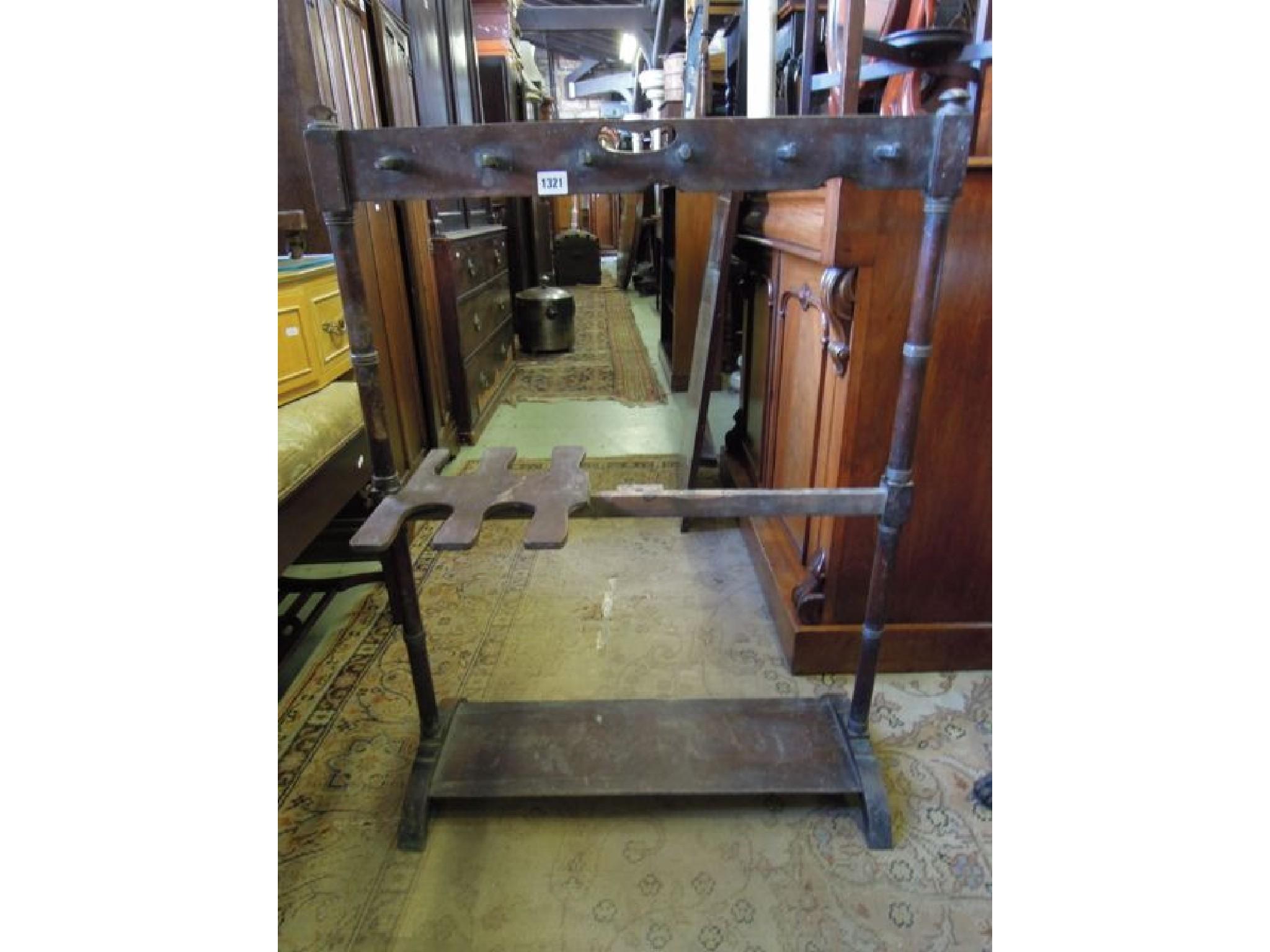 Appraisal: A th century mahogany boot stand raised on ring turned