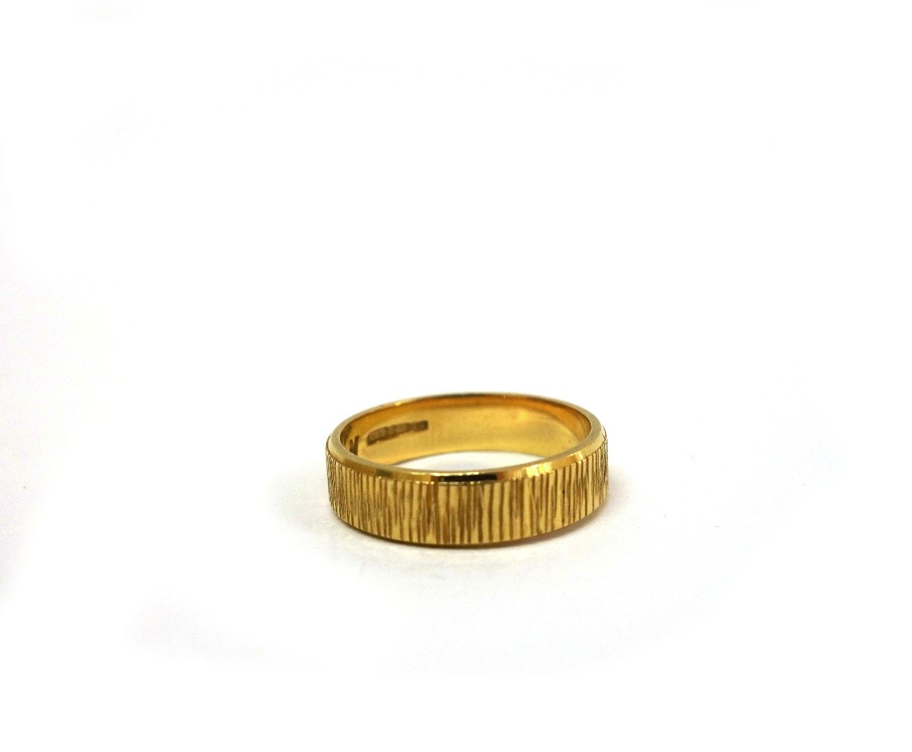 Appraisal: An ct yellow gold wedding band Birmingham with a textured