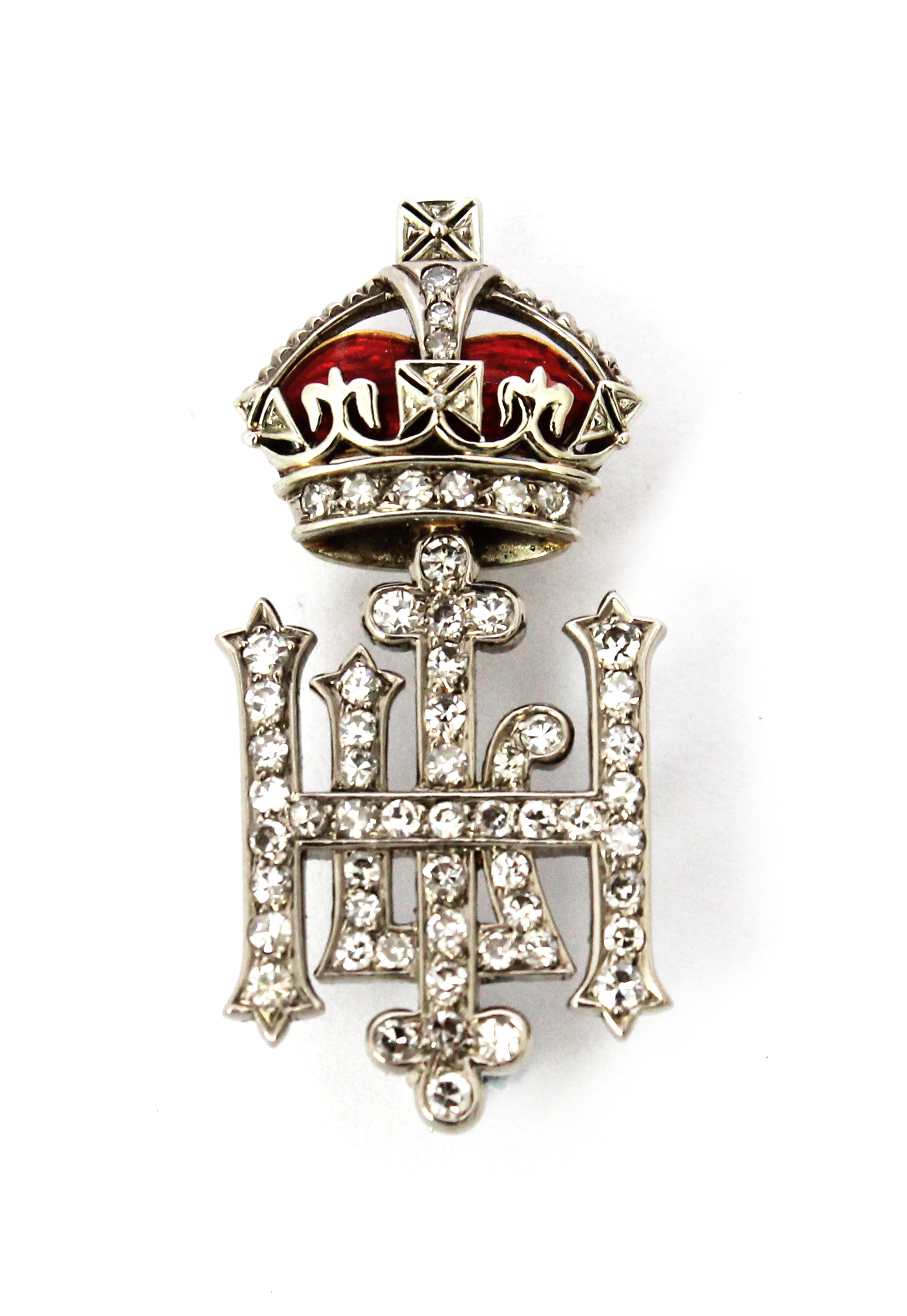 Appraisal: A diamond set and red enameled military brooch designed as