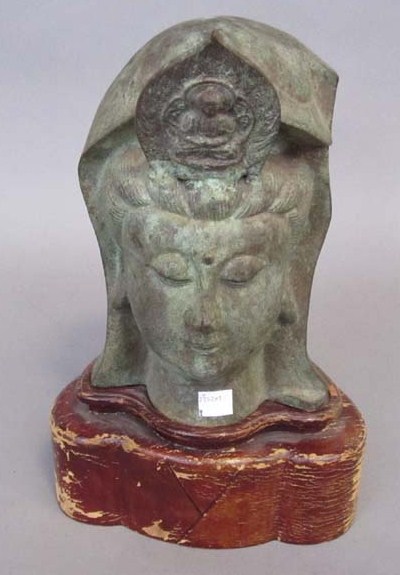 Appraisal: ORIENTAL HEAD OF A DEITY Bronze in a green patina