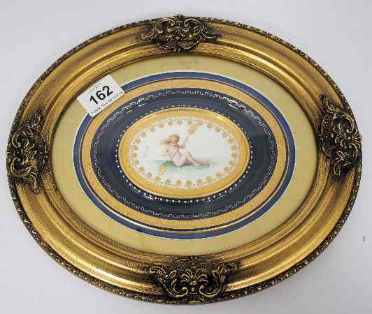 Appraisal: Minton gilded oval plaque handpainted with cupid with paddle on