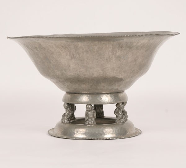 Appraisal: Hammered pewter bowl on raised base supported by kneeling figures