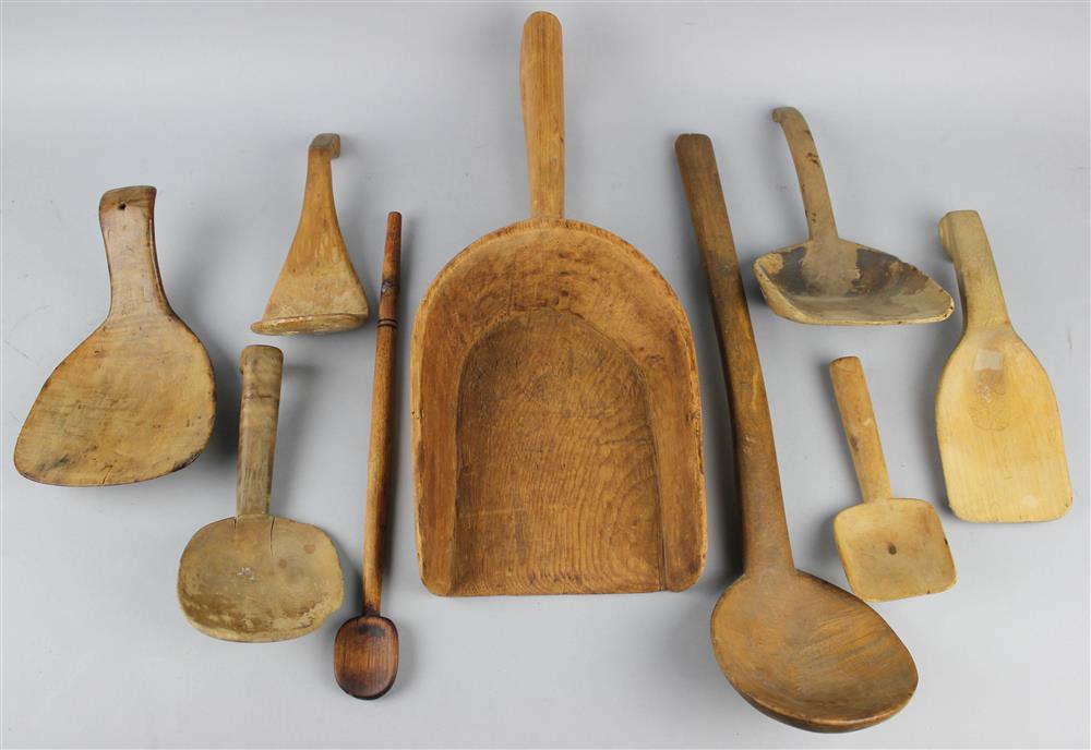 Appraisal: NINE CARVED WOOD SCOOPS AND UTENSILS one with figural carved