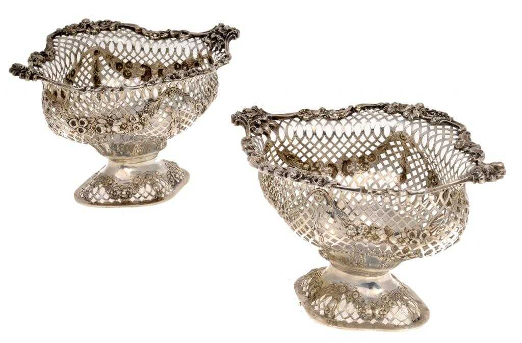 Appraisal: A PAIR OF VICTORIAN SWEETMEAT BASKETS embossed with swags and