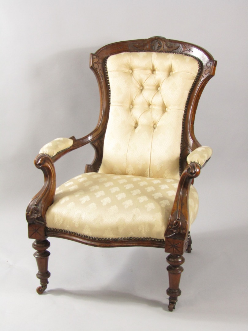 Appraisal: A Victorian mahogany armchair with carved crest rail button back