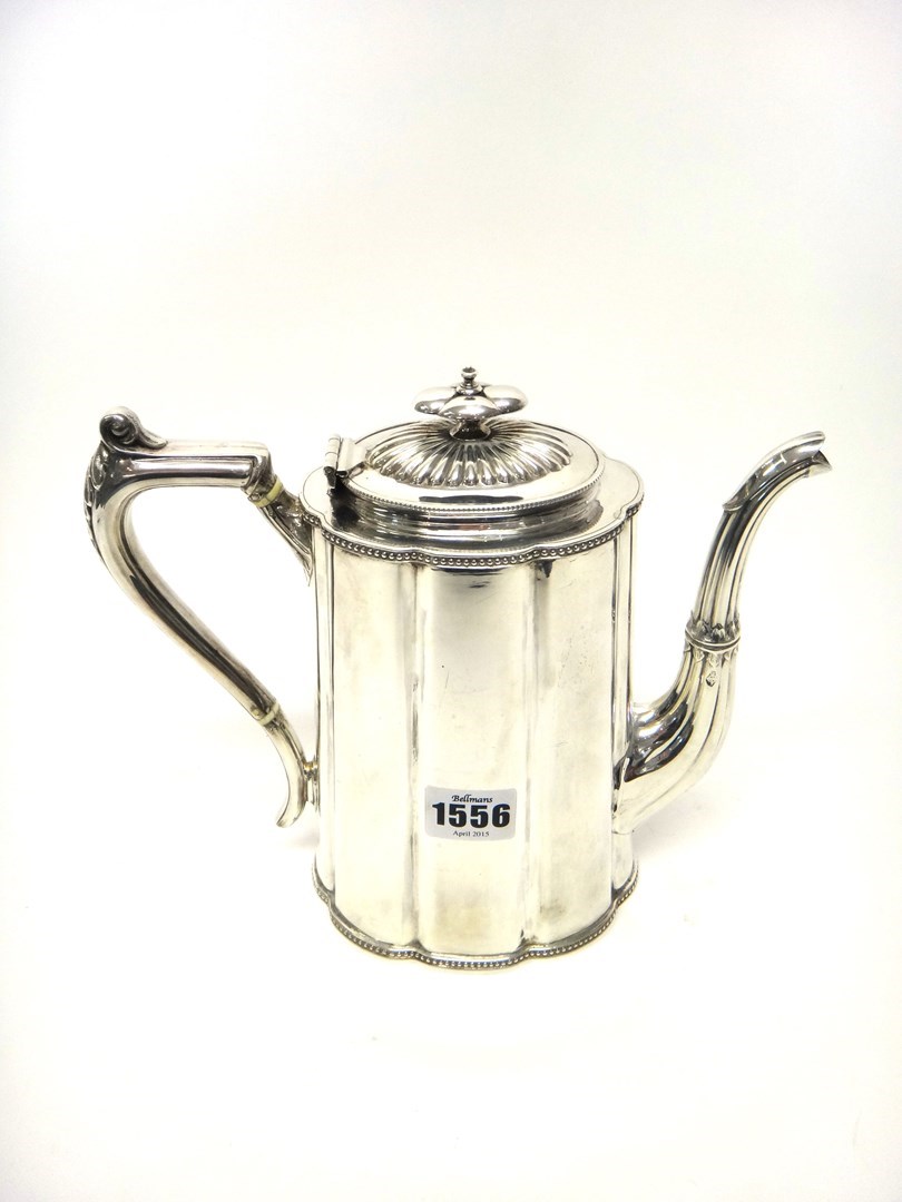 Appraisal: A Victorian silver coffee pot of tapered oval form decorated