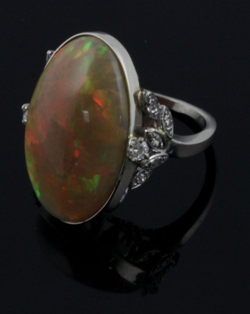 Appraisal: An opal ring the large oval stone to diamond set