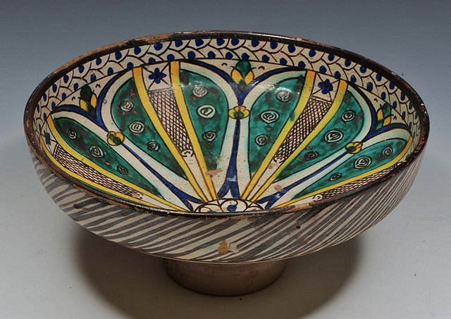 Appraisal: A PERSIAN POLYCHROME PEDESTAL BOWL with radiating central design from