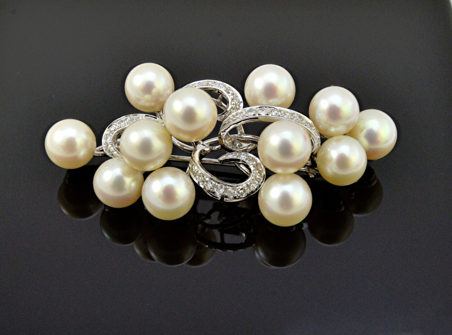 Appraisal: A white gold cultured pearl and diamond set brooch in