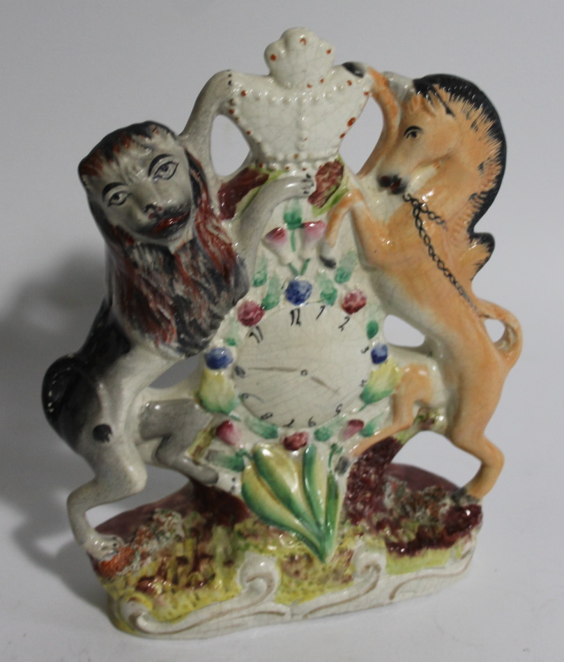 Appraisal: A mid- thC Staffordshire flatback lion and unicorn clock group