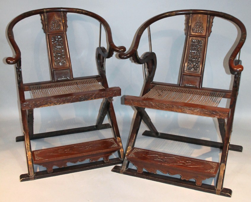 Appraisal: A pair of Chinese hardwood folding chairs each with hoop