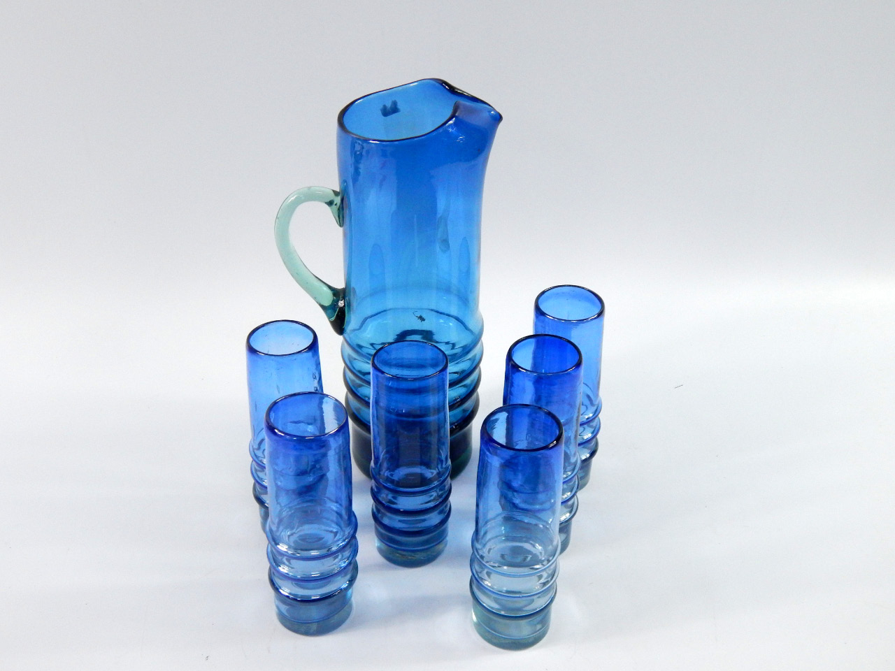 Appraisal: A blue glass lemonade set with horizontal fluted decoration comprising