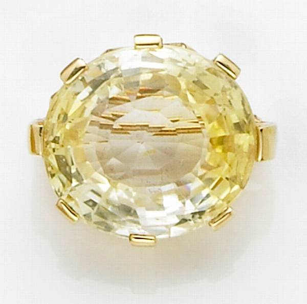 Appraisal: Yellow Sapphire Brooch Sri Lanka An oval-cut stone of pale