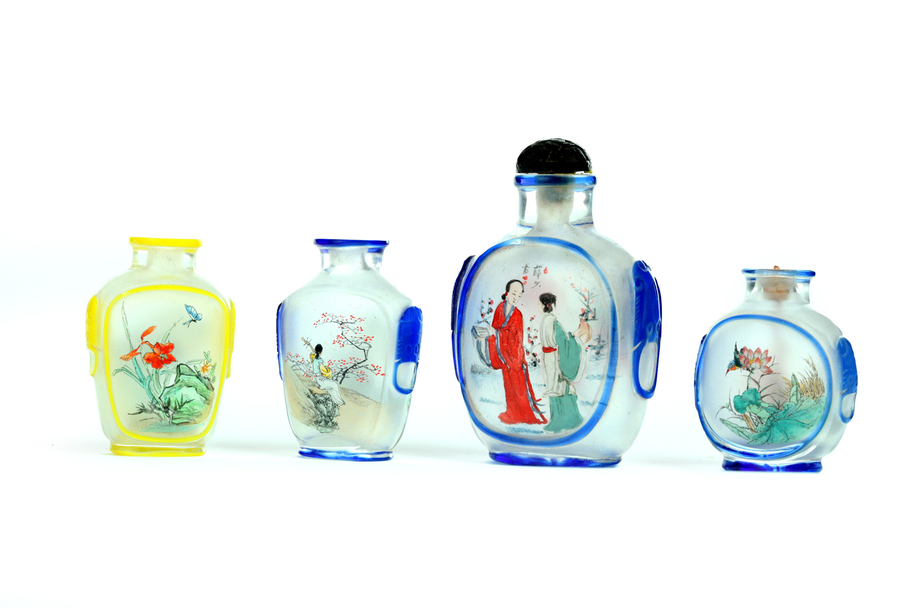 Appraisal: FOUR SNUFF BOTTLES China th century Colorful reverse glass painted