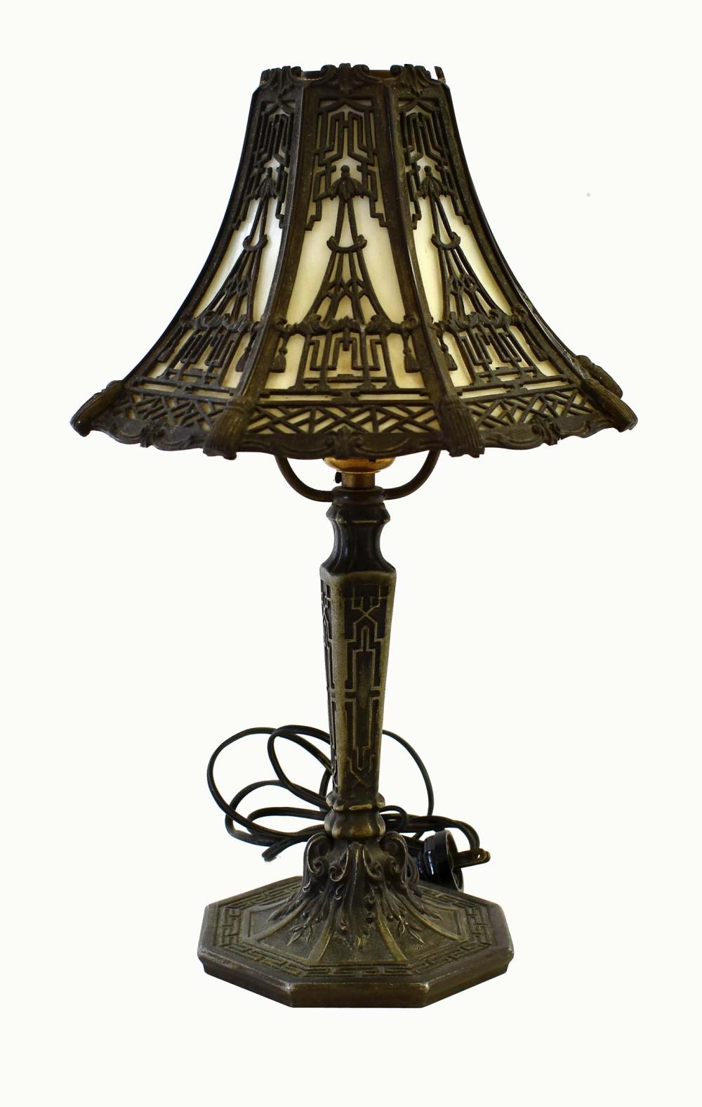 Appraisal: AMERICAN PATINATED METAL AND GLASS BOUDOIR LAMPThe shaped shade with