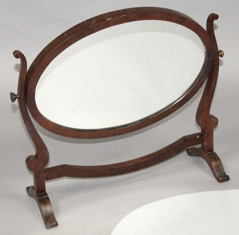 Appraisal: A late thC mahogany table mirror the oval glass flanked