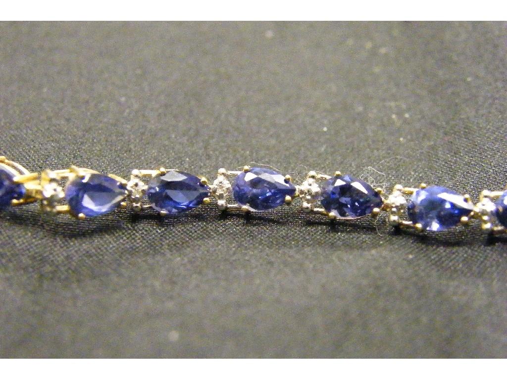 Appraisal: Attractive yellow gold blue pear shaped stone set line bracelet