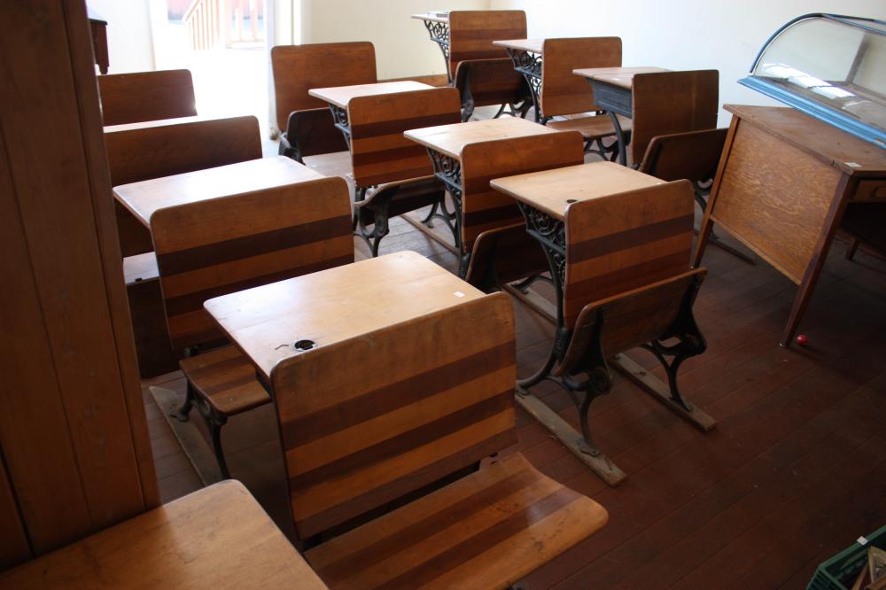 Appraisal: TEN ANTIQUE SCHOOL DESKS maple with cast iron supports fold-up