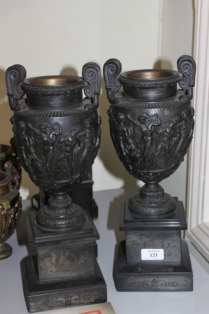 Appraisal: A PAIR OF VICTORIAN BLACK SLATE STANDS supporting cast urns