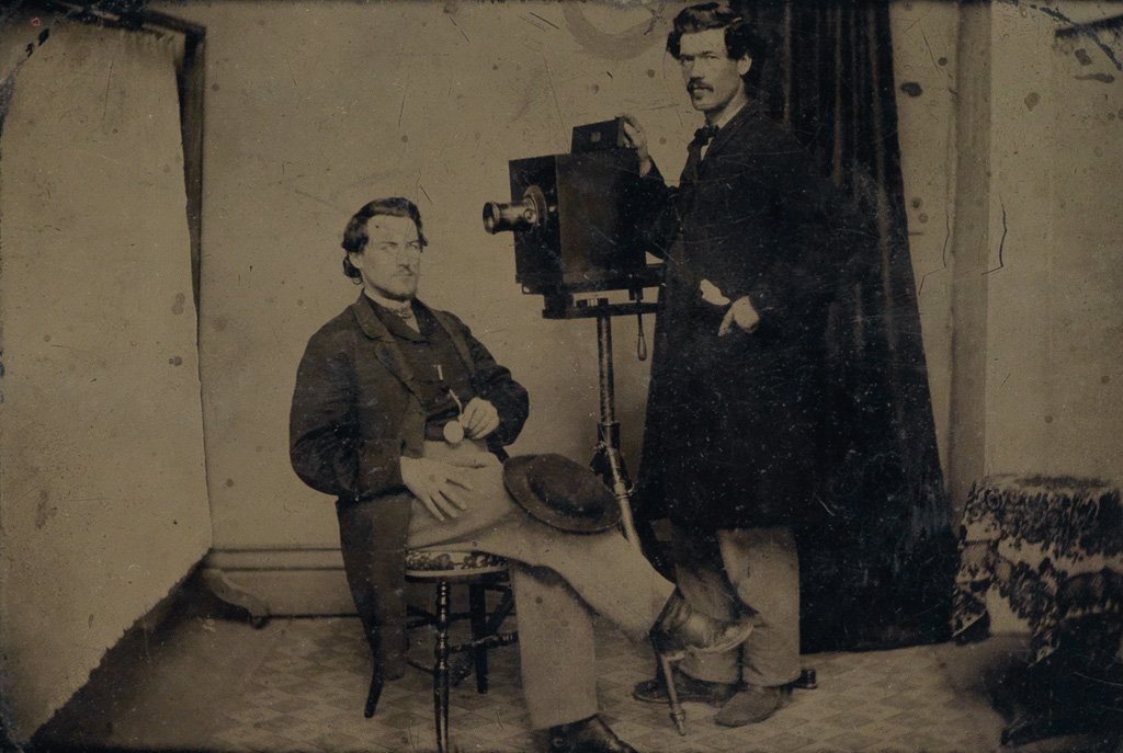 Appraisal: OCCUPATIONAL TINTYPE Half-plate tintype of a photographer and subject in