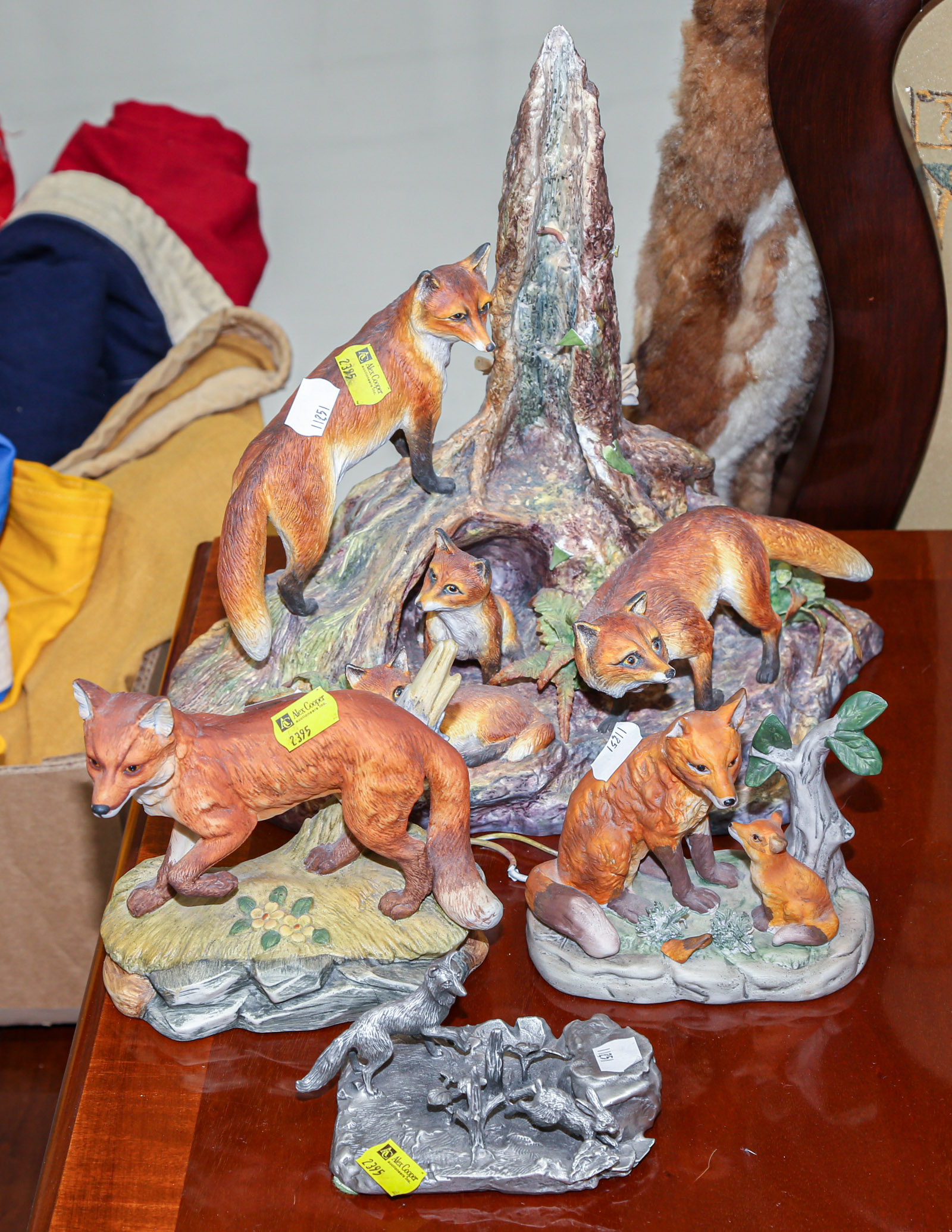 Appraisal: FOUR PORCELAIN PEWTER FOX GROUPINGS The large group of foxes